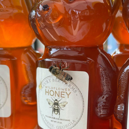 Lucky Bee Farms Honeycomb Jar from Athens, GA, featuring raw, unfiltered honey, close-up of a bee on the label and jar, highlighting natural sweetness.