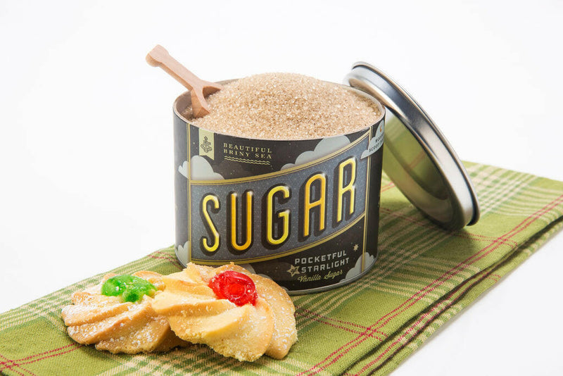 Beautiful Briny Sea | Cane Sugars - Pocketful of Starlight | Vanilla with a wooden scoop in a bowl of brown sugar, highlighting its gourmet culinary enhancement.