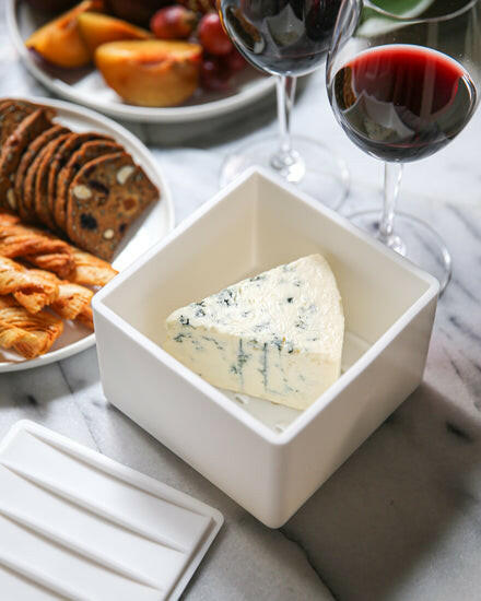 CapaBunga | Cheese Vaults - Soft Cheese - Biscuit (yellow) shown next to a wine glass and blue cheese, highlighting its innovative cheese preservation for gourmet enjoyment.
