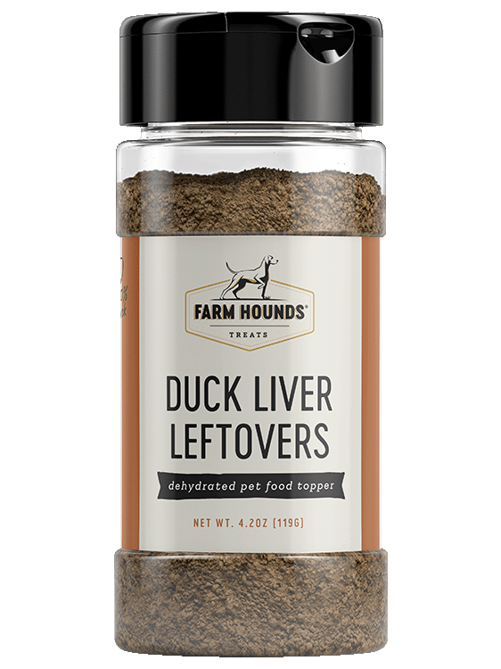 Close-up of Farm Hounds | Food Toppers - Duck Liver, highlighting the container and black device, representing sustainable, nutrient-rich sprinkles for enhancing meals.