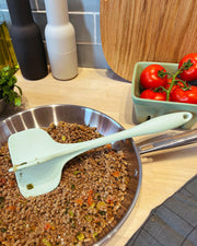 GIR Quad Chopper in action, breaking up food in a pan, highlighting its utility for efficient meal preparation.