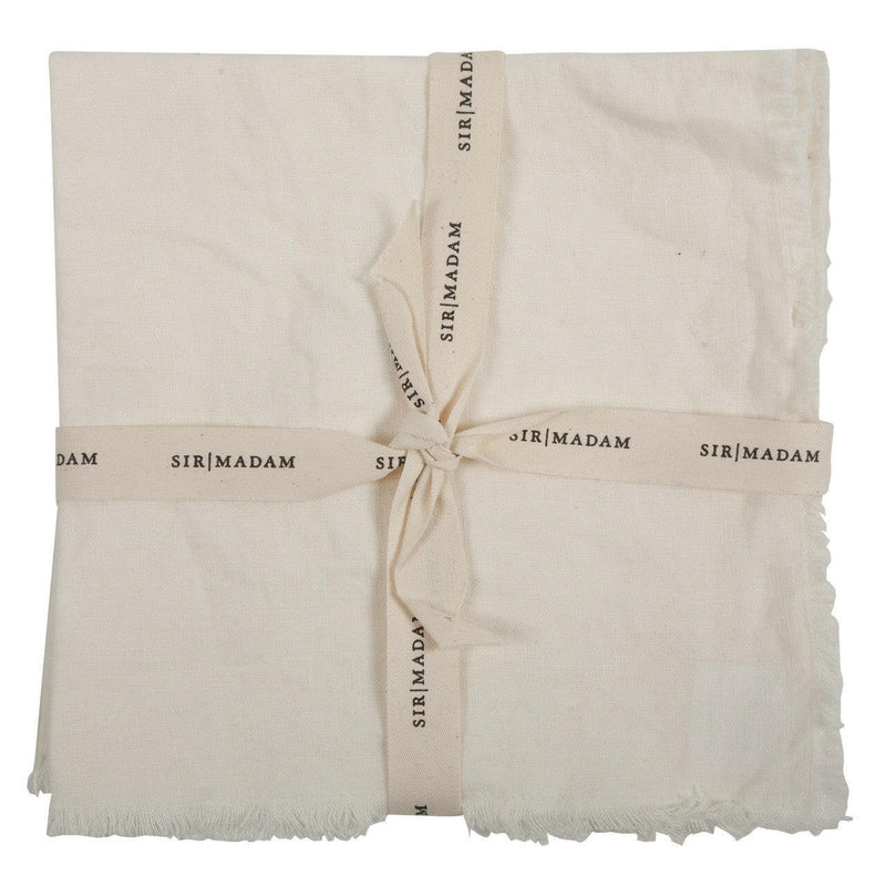 Sir|Madam Linen Frayed Edge Napkins, set of four, featuring close-up details of white linen fabric with frayed edges and a buttonhole.