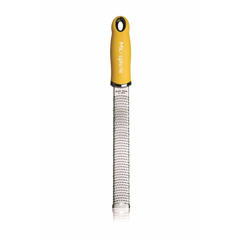 Microplane Premium Classic Zester Grater with a yellow handle, ideal for zesting citrus or grating cheese, featuring sharp stainless steel blades for precise results.
