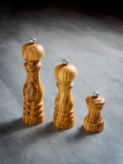 Three Peugeot Paris Classic Olive Wood Mills, 9-inch, with metal knobs, showcasing elegant craftsmanship and sustainable design for seasoning with precision.