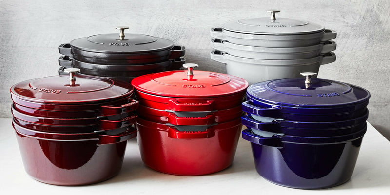Staub Stackable 4-in-1 Cast Iron Cookware Set - Graphite, featuring a cocotte, braiser, and grill pan with a universal lid, designed for efficient storage.