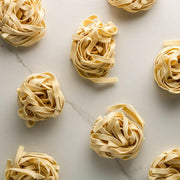 Bona Furtuna | Organic Italian Pastas - Linguine displayed on a marble surface, showcasing artisan craftsmanship and authentic Sicilian heritage with heirloom wheat.