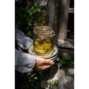 Hands hold Le Parfait | Rounded French Glass Storage Jars - 3L, filled with pickled lemons, showcasing elegant, versatile storage from Athens Cooks.