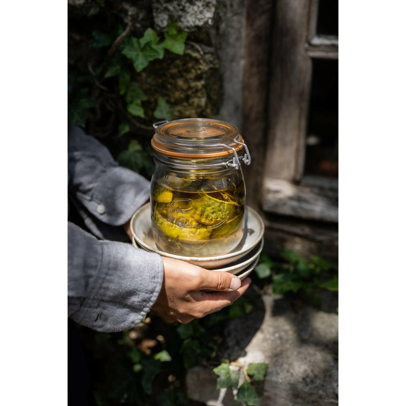 Hands hold Le Parfait | Rounded French Glass Storage Jars - 3L, filled with pickled lemons, showcasing elegant, versatile storage from Athens Cooks.