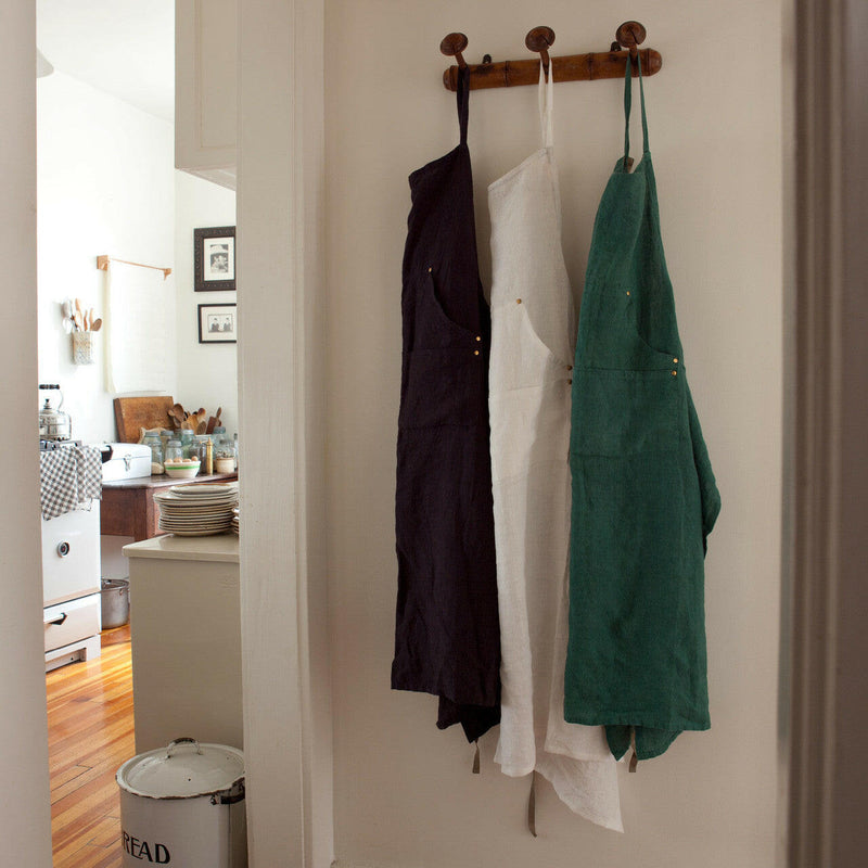 Sir|Madam Linen Grand Apron - Faded Black hanging neatly, showcasing adjustable neck loop, side-vents, and waist-level pockets, ideal for kitchen enthusiasts at Athens Cooks.