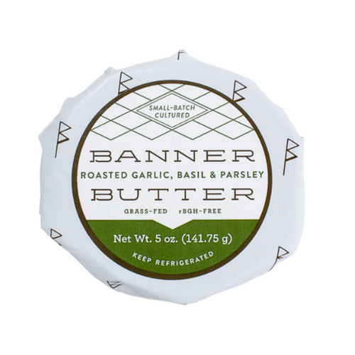 Banner Butter - Lemon Chive in a round white and green wrapper, featuring bold black text, ideal for enhancing culinary creations with its vibrant, savory flavor.