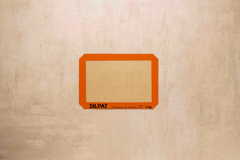 Silpat Nonstick Baking Mats with Silband, featuring reinforced fiberglass mesh for nonstick baking, available in various sizes, enhancing baking efficiency at Athens Cooks.