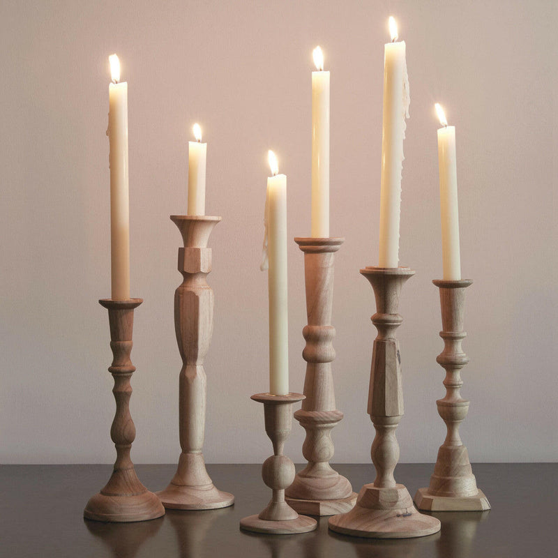 Sir|Madam | Wooden Candlesticks - Tall Georgia No. 3, a hand-carved plantation hardwood candlestick, elegantly displayed among varied silhouettes on a table.